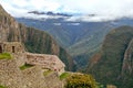 Abandoned ruins of Machu Picchu Incan citadel, the maze of terraces and walls rising out of the thick undergrowth, Peru Royalty Free Stock Photo