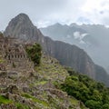 Abandoned ruins of Machu Picchu Incan citadel, the maze of terraces and walls rising out of the thick undergrowth, Peru Royalty Free Stock Photo