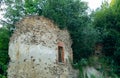 Abandoned ruins of a medieval building outgrown with plants