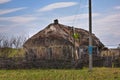 Abandoned Russian village. Ruins of rural house with thatched roof