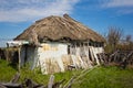 Abandoned Russian village. Ruins of rural house with thatched roof