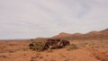 Abandoned rusted car wreck in a desert. The car rolled in the accident and was flattened. Royalty Free Stock Photo