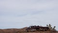 Abandoned rusted car wreck in a desert. The car rolled in the accident and was flattened. Royalty Free Stock Photo