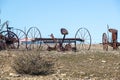 Abandoned, rusting vintage farm equipment in an open field Royalty Free Stock Photo