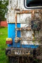 Abandoned rusty car blue coloured broken glass old tail lamp