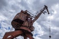 Abandoned, rusty, damaged port crane.