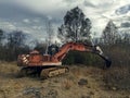 Abandoned rusty excavator on the field