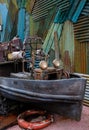 Abandoned rusty metal ship parked in front of vintage wall Royalty Free Stock Photo