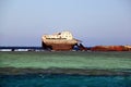 Abandoned rusty ship in blue sea waves Royalty Free Stock Photo