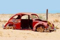 Abandoned rusty Volkswagen Beetle in desert, Namibia, Africa