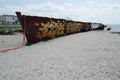 An abandoned rusty warship on the sand of the Baltic Sea. Hel. Royalty Free Stock Photo