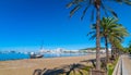 Abandoned sail boat on the beach. Mid morning sun on Ibiza waterfront. Warm sunny day along the beach in St Antoni de Portmany. Royalty Free Stock Photo