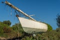 Abandoned sailboat in a field