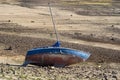 Abandoned sailboat on the shore rusty dry land by drought vertical