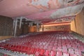 Abandoned seats chairs in an old abandoned collapsing theater interior with a collapsed ceiling. Royalty Free Stock Photo