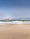 Abandoned shipwreck of the stranded Zeila vessel at the Skeleton Coast near Swakopmund in Namibia, Africa, with many cormorants si