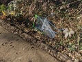 Abandoned Shopping Trolley Basket in Woodland by The Side of a Path Thrown In and Discarded