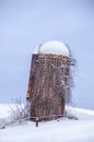 Abandoned silo in snow field