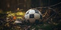 Abandoned Soccer Ball and Old Shoe Lying in Old Soccer Field. Vintage Classic Leather Worn Ball with Soccer Shoe