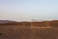 Abandoned soccer goal in the desert at sunset
