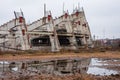 Abandoned stadium concrete reinforcement foundation construction frame shapes with tv-tower on the background