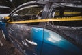 An abandoned, stolen burnt out blue car parked on the sideway parking spotÃÂ± tied with yellow do not cross stripe