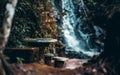 Abandoned stone table in jungle with waterfall behind Royalty Free Stock Photo