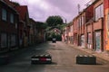 Abandoned street with road blocks and buildings covered with graffiti in Doel, Belgium