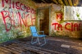 abandoned summer chair inside of an empty room decorated by various graphitti in gibraltar...IMAGE