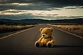 Abandoned teddy bear in the middle of nowhere on a lonely road