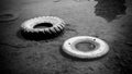 Abandoned tire on the water sea or lake pond with black and white style color