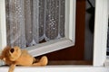 Abandoned toy, open window. Royalty Free Stock Photo
