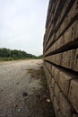 Abandoned tracks next to a functioning railroad seen from a clearing of a railroad station on a cloudy day in the italian