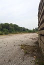 Abandoned tracks next to a functioning railroad seen from a clearing of a railroad station on a cloudy day in the italian