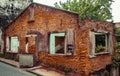 Abandoned tumbledown house, windows and door removed uninhabitable condition, build with refractory clay firebricks, isolated in
