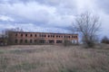 An abandoned two-story brick building. Cloudy evening landscape. Cloudy sky