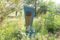 Abandoned unkempt grave, crypt, tombstone monument, in dry grass, against the background of the cemetery Royalty Free Stock Photo