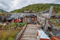 Abandoned village with crumbling empty buildings and abandoned cars in Khakassia