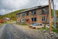 Abandoned village with crumbling empty buildings and abandoned cars in Khakassia