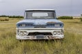 Abandoned vintage blue and white pick up truck on Saskatchewan prairies
