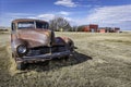 Abandoned vintage car and buildings in ghost town in Saskatchewan