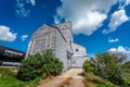 An abandoned vintage grain elevator in Battrum, Saskatchewan with a train beside it