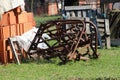 Abandoned vintage retro rusted agricultural farming equipment used to work with tractors on soil left in backyard surrounded with