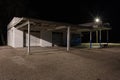 Abandoned vintage service station at night