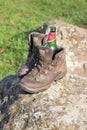 Abandoned walking boots with beer bottle