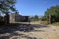 Abandoned warehouse behind a closed gate on a sunny day in the countryside Royalty Free Stock Photo