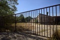 Abandoned warehouse behind a closed gate on a sunny day in the countryside Royalty Free Stock Photo