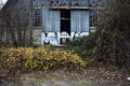 Abandoned warehouse with broken windows in a park on a cloudy day in winter