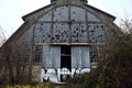 Abandoned warehouse with broken windows in a park on a cloudy day in winter