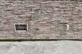 Abandoned warehouse window. Rusty grate window. Outdoor faucet water tap with white PVC pipe and reed valve on light Royalty Free Stock Photo